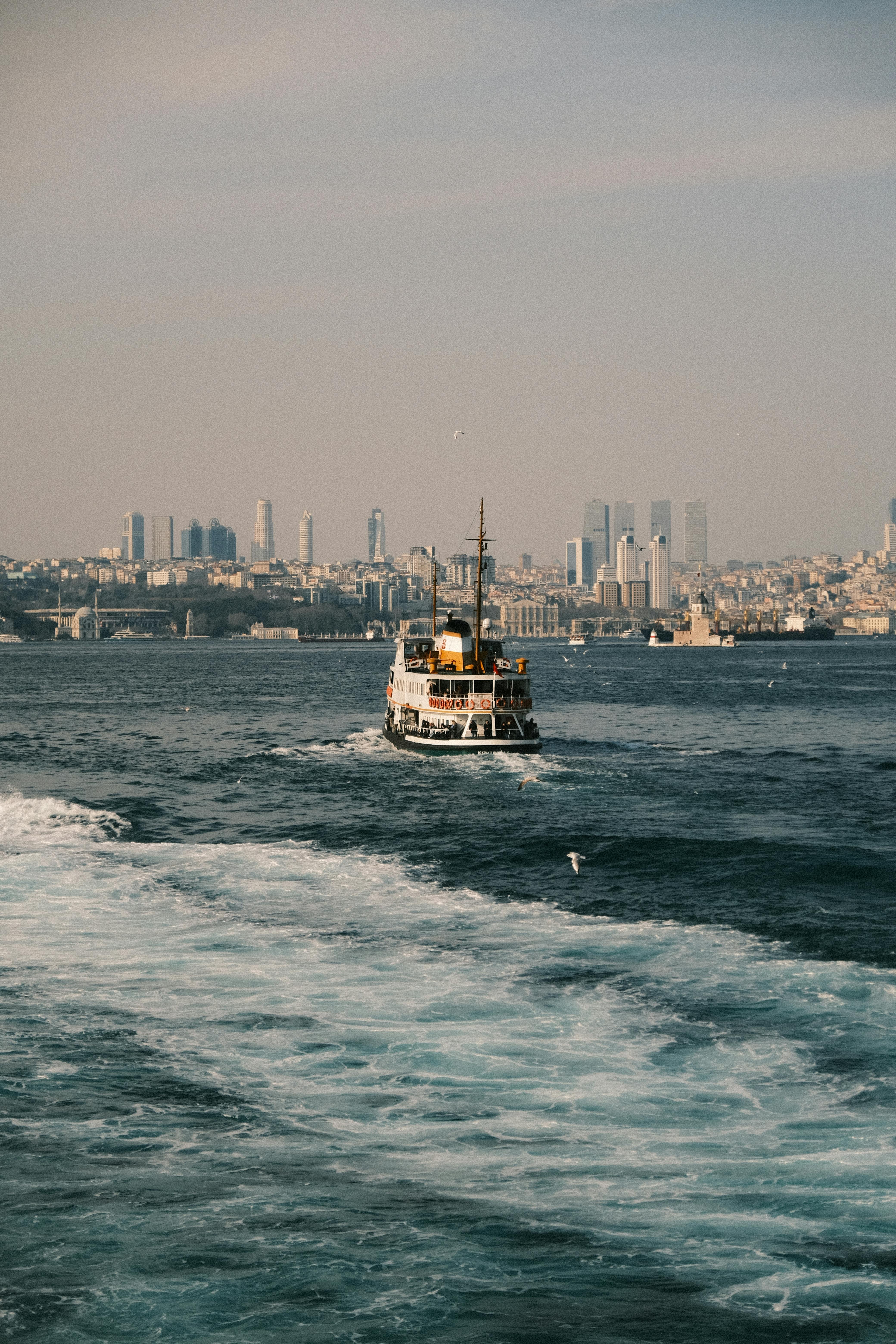 Ferry sails through Istanbul, showcasing the city's iconic skyline and bustling waterways.