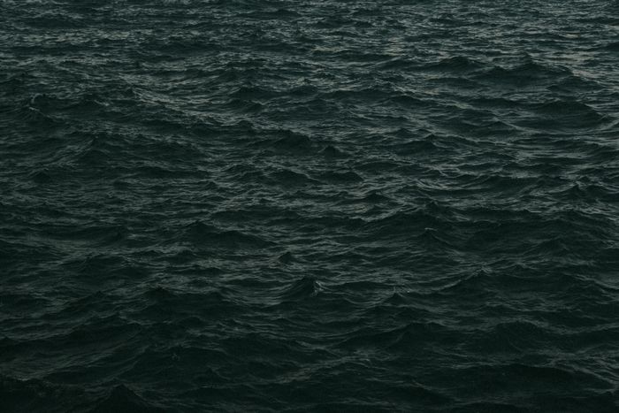 Dark ocean swell at dusk — photo by Mete Kaan Özdilek on Pexels