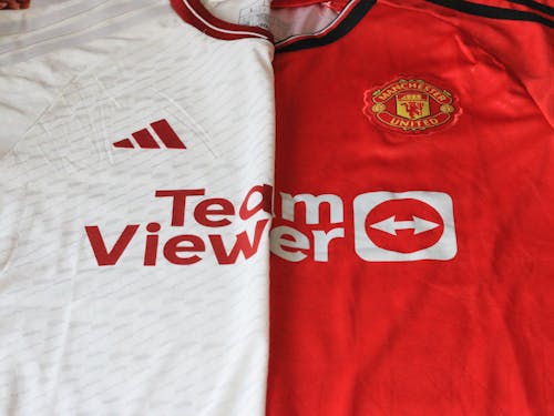 Free Close-up of Manchester United 2023 jerseys showcasing red and white designs. Stock Photo
