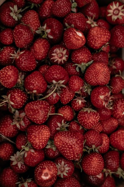 Vibrant close-up of fresh red strawberries showcasing natural texture and freshness.