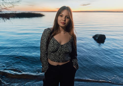 A woman standing in front of the water