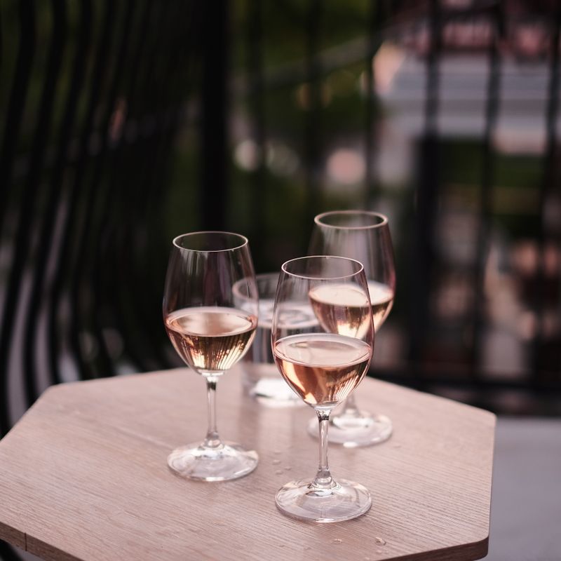 Four glasses of chilled rosé on a small café table — photo by Benoit Roy on Pexels