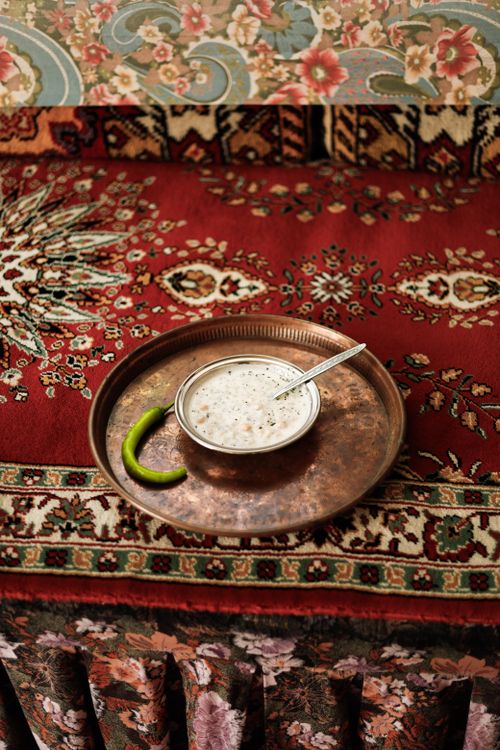 Free Authentic Turkish Ayran served on a traditional carpet with intricate patterns. Stock Photo