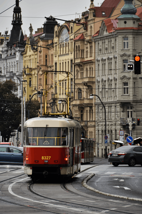 A red and white trolley car on a street