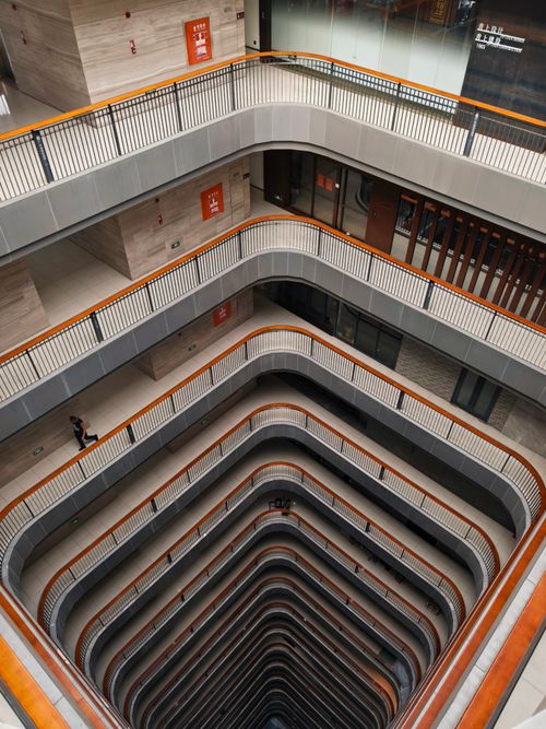 Free Modern building interior featuring balconies and vertical perspective. Stock Photo