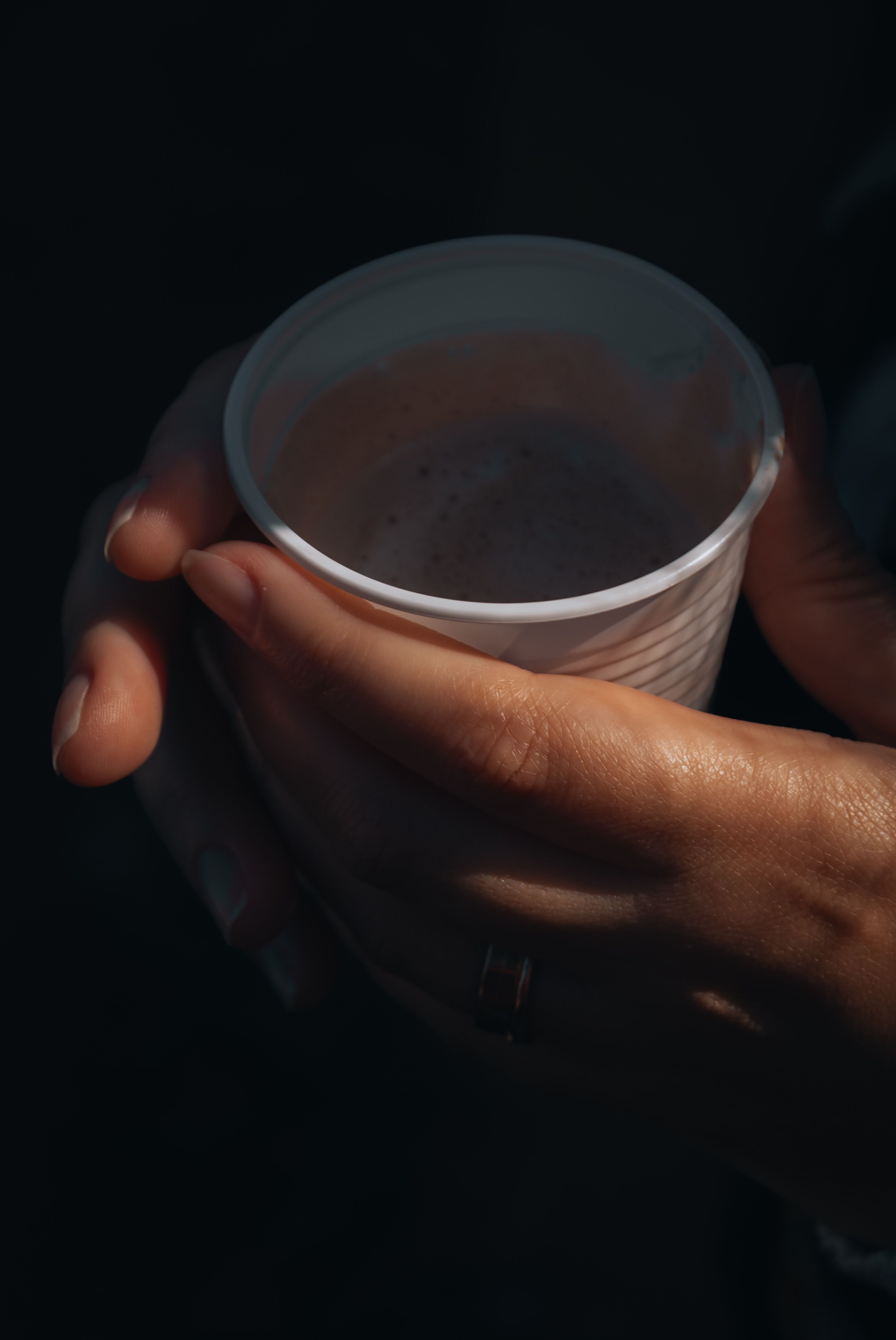 Warm hands holding a disposable cup in Itu, SP, Brazil, capturing a cozy moment.. warm, hands, holding