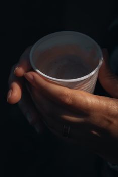 Warm hands holding a disposable cup in Itu, SP, Brazil, capturing a cozy moment.. warm, hands, holding