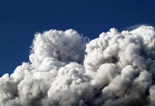 Majestic cumulus clouds forming a dramatic skyscape with a vibrant blue sky background.