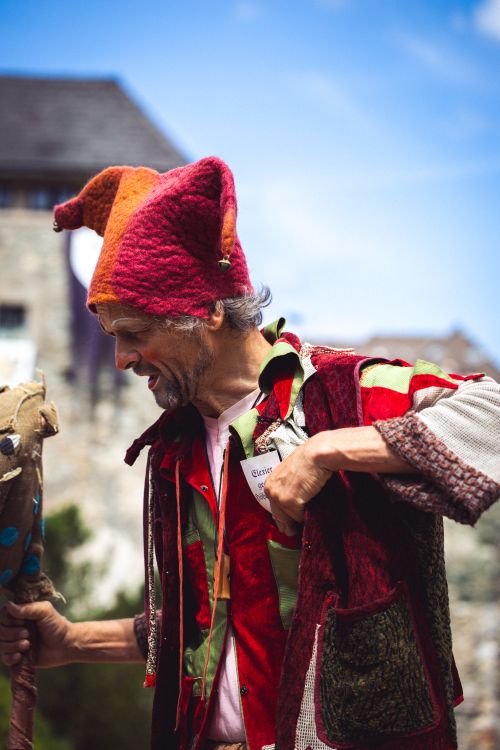 Free Colorful jester in traditional clothing performing outdoors, showcasing cultural heritage. Stock Photo
