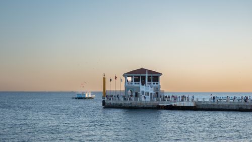 Free Stunning sunset view of Moda Pier in Istanbul, capturing serene sea and ferry. Stock Photo