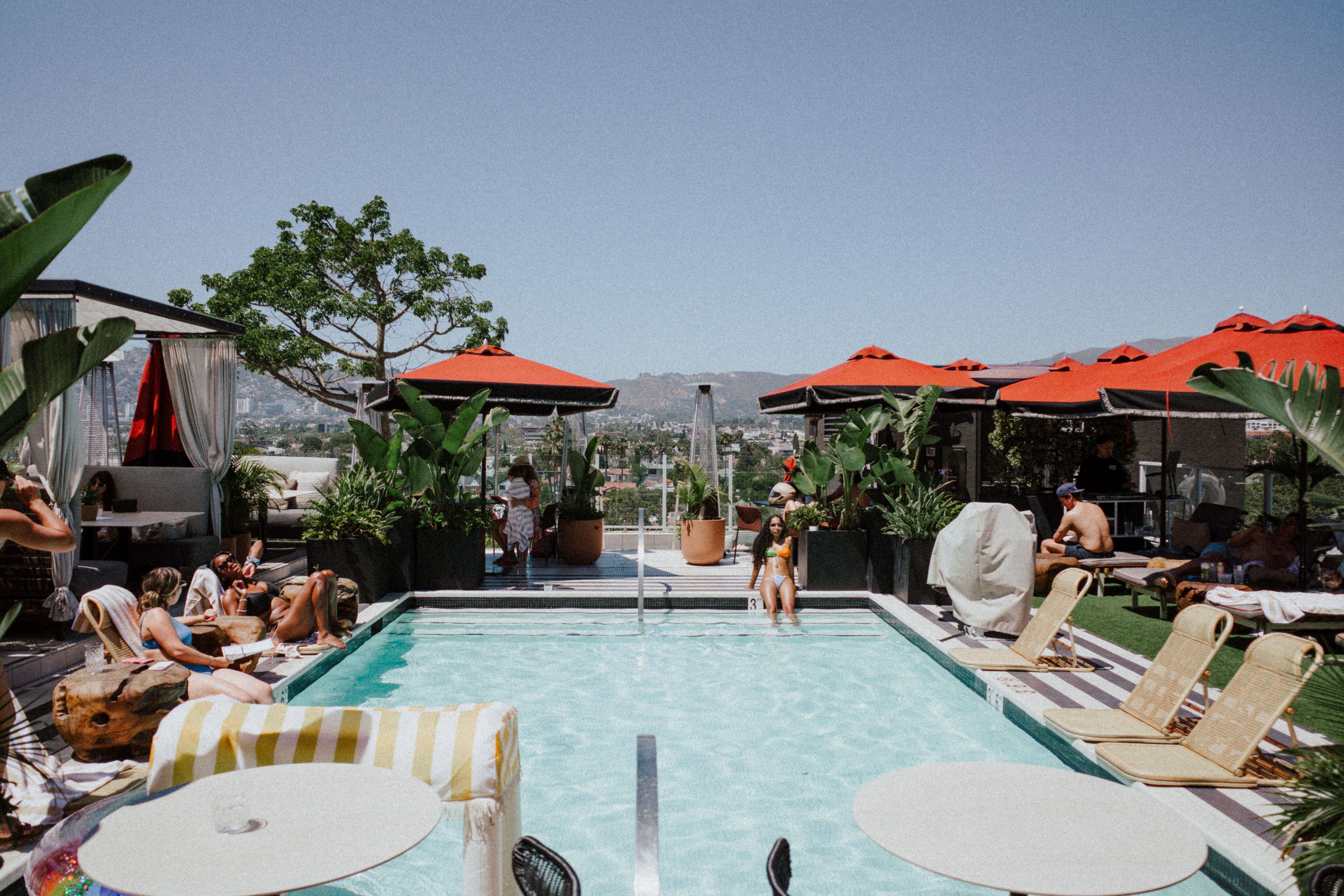 Hollywood Hills estate pool party at sunset with panoramic city views