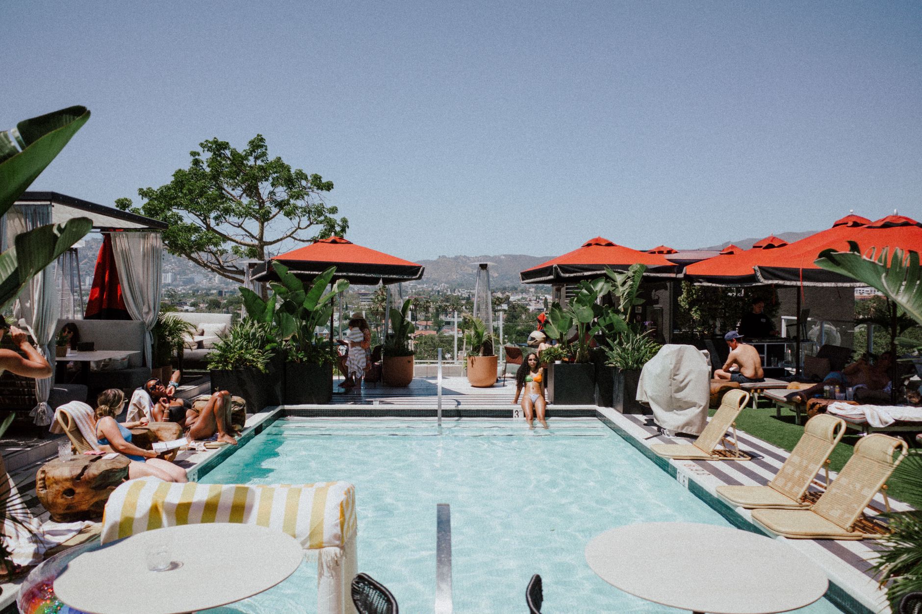 Hollywood Hills estate pool party at sunset with panoramic city views