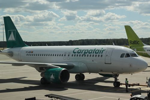Free Carpatair Airbus A319 on airport apron in Mārupe, Latvia under sunny skies. Stock Photo