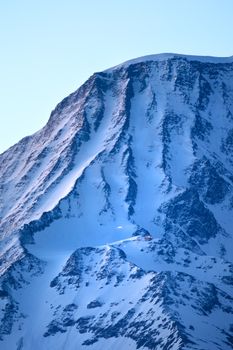 Majestic winter view of Mont Blanc's snowy peak at Franco-Italian border.