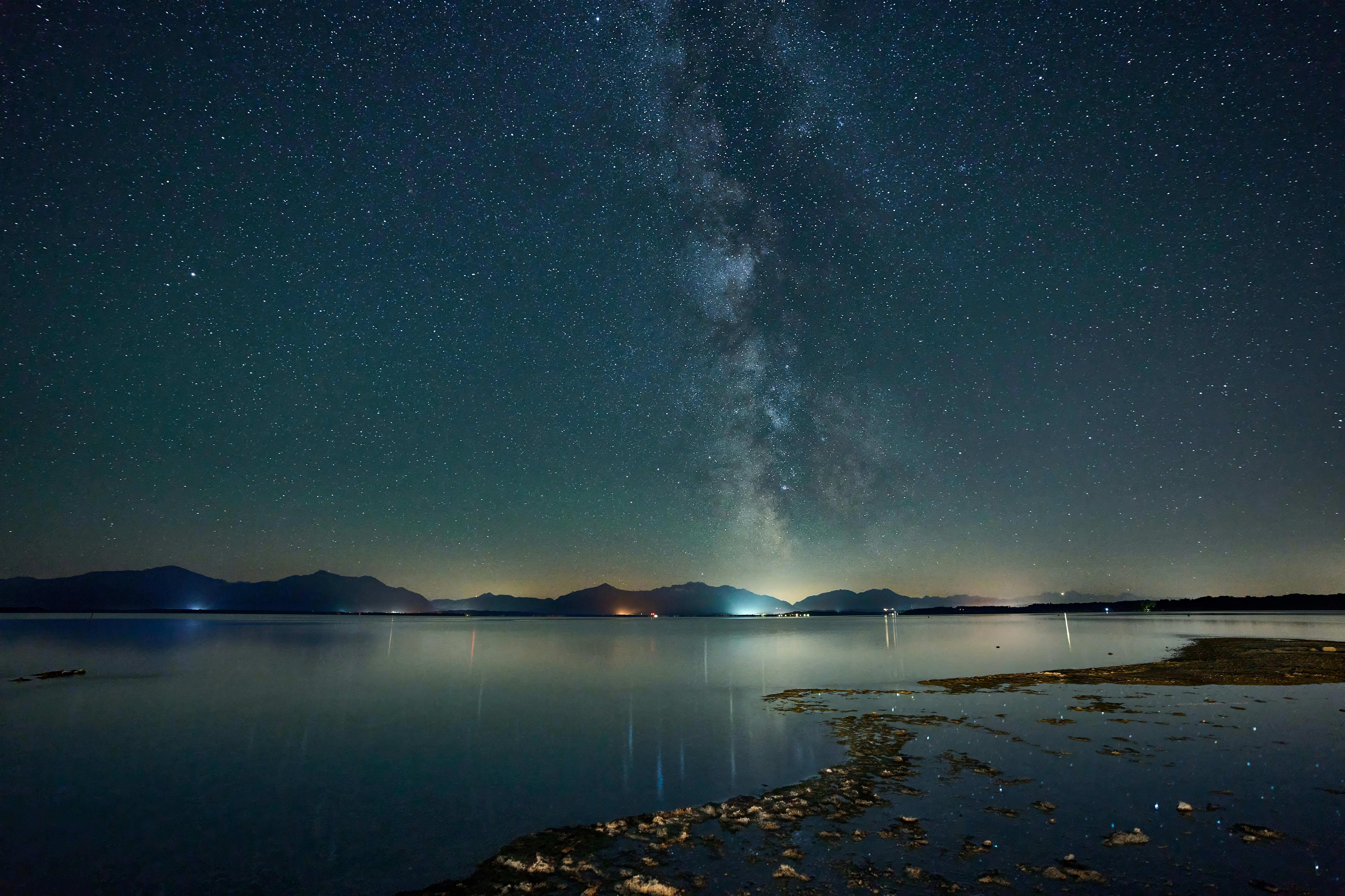 Capture the mesmerizing Milky Way over Seeon Lake, showcasing the starry night sky and tranquil waters.