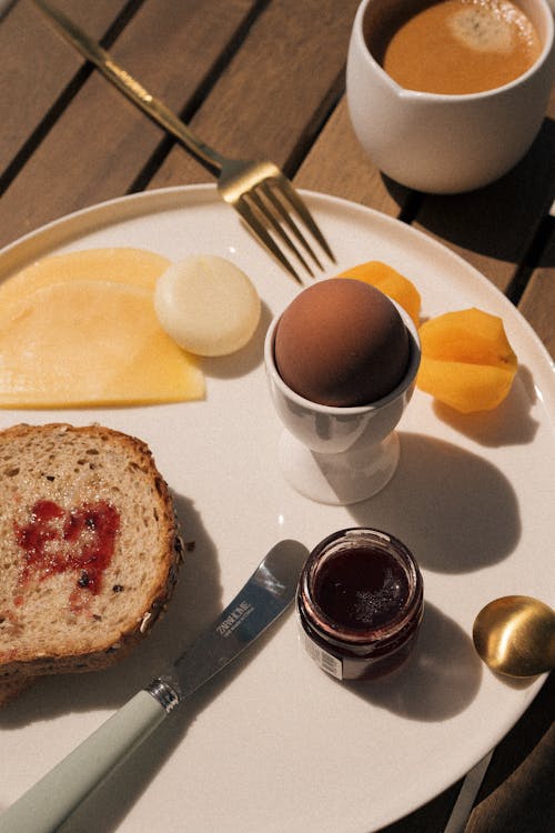 Free A breakfast plate with an egg, toast and jam Stock Photo