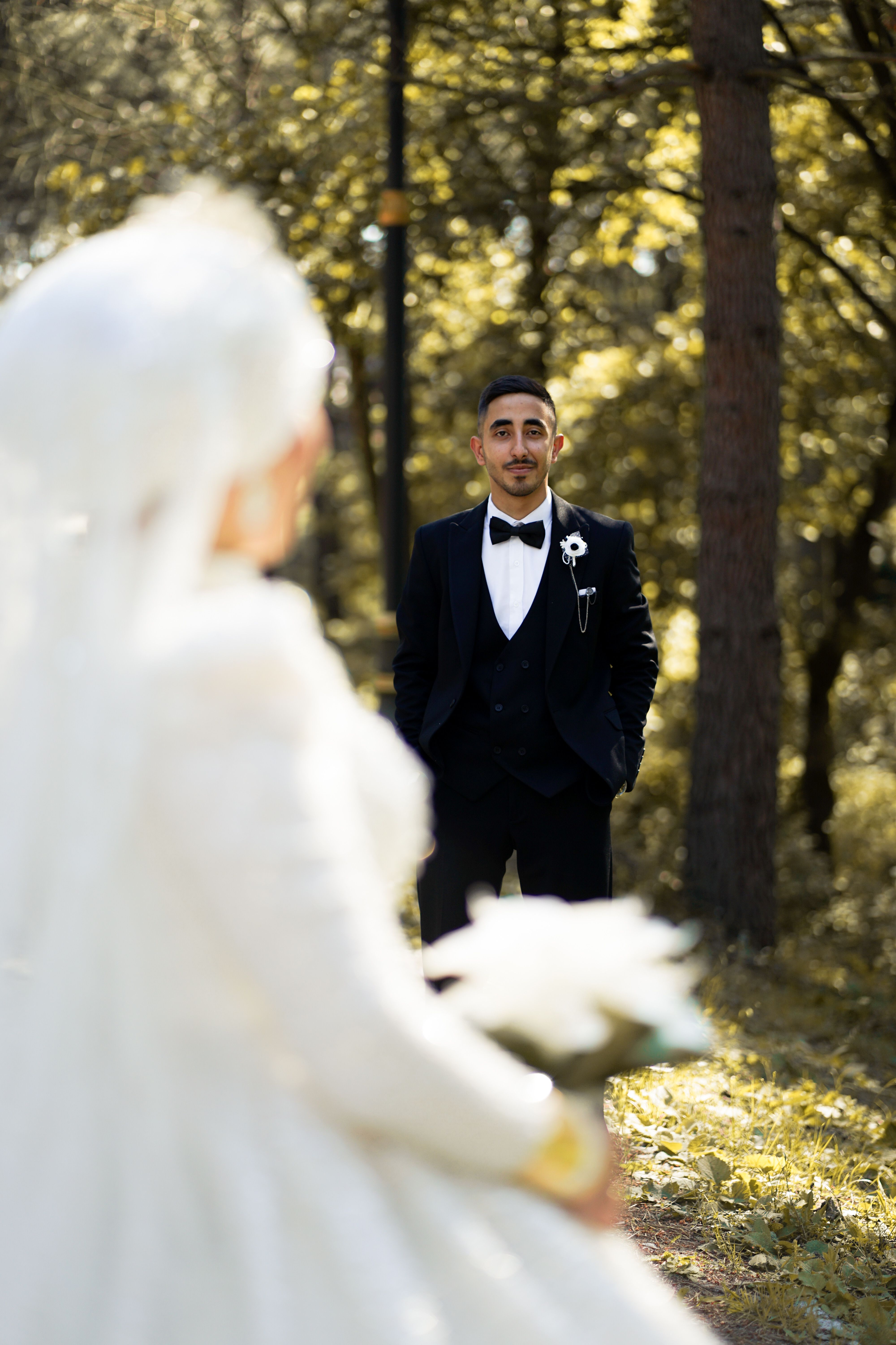 Wedding photographer capturing a couple in a forest