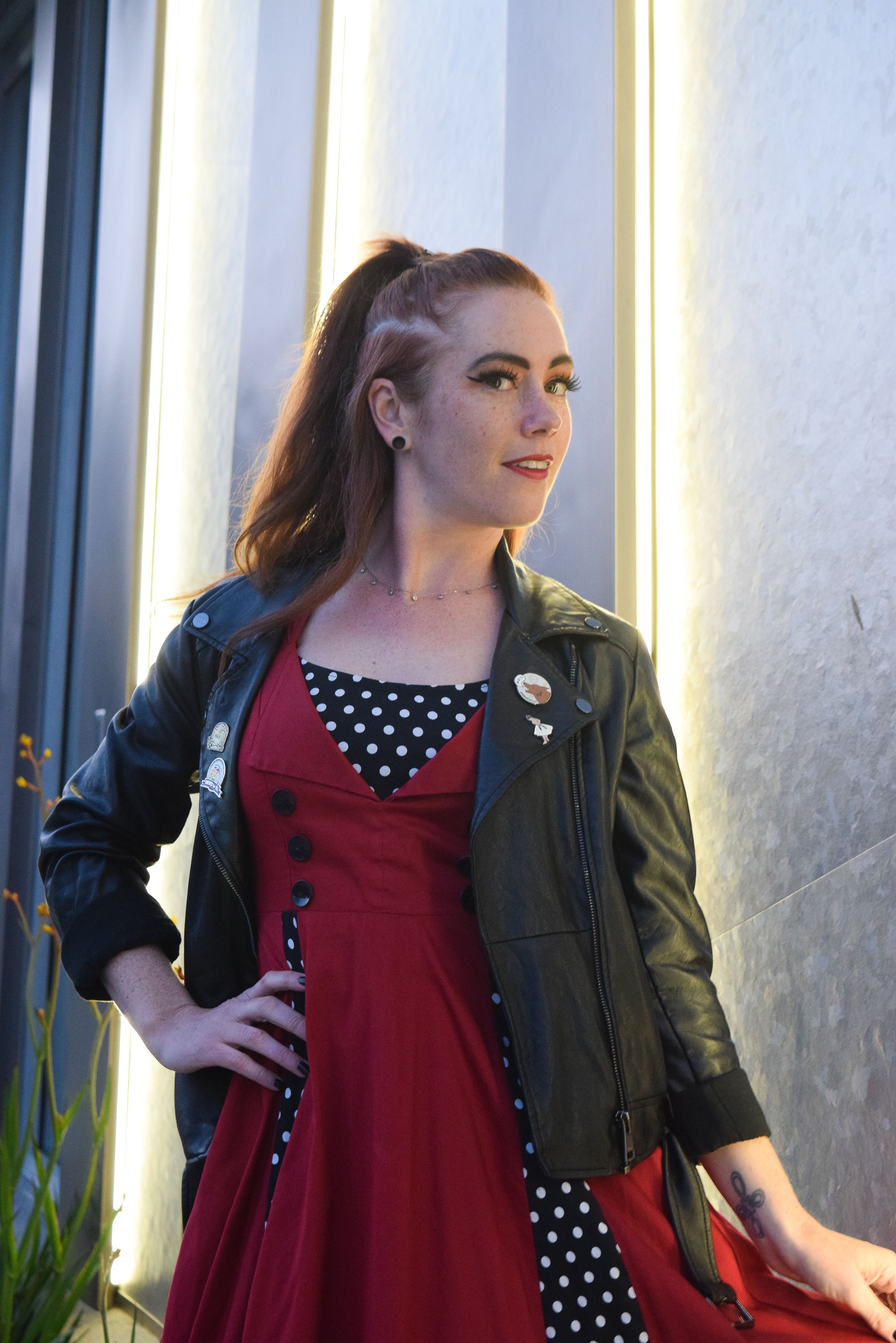 A Woman in Red Dress Wearing Black Leather Jacket  Free Stock Photo