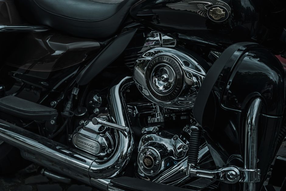Detailed closeup of a shiny Harley Davidson motorcycle engine showcasing chrome parts.