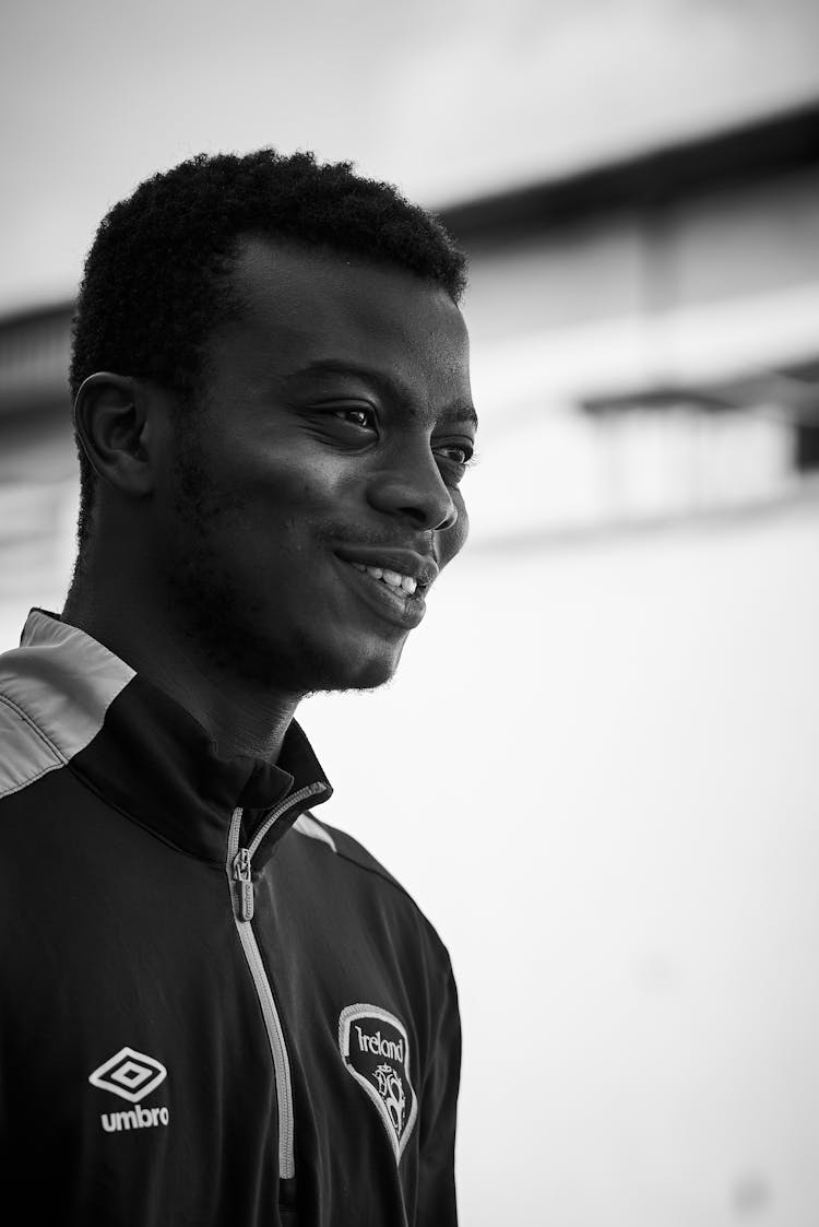 A Black And White Photo Of A Man Smiling