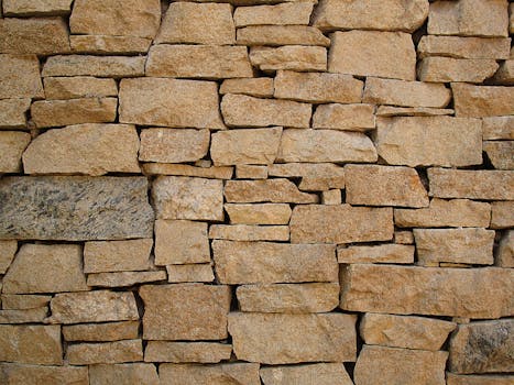 Close-up of a rustic stone wall showcasing natural colors and textures.