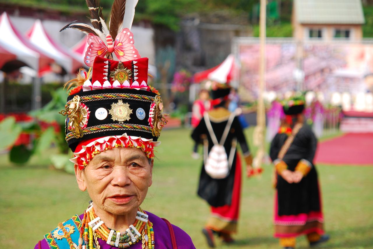 senior woman in ornate traditional dress at cultural celebration outdo