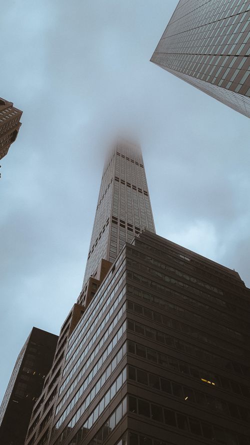 Free A towering New York City skyscraper piercing through the fog, showcasing urban architecture. Stock Photo