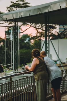 A couple enjoys the view at sunset in Kuala Lumpur, capturing daily life moments.