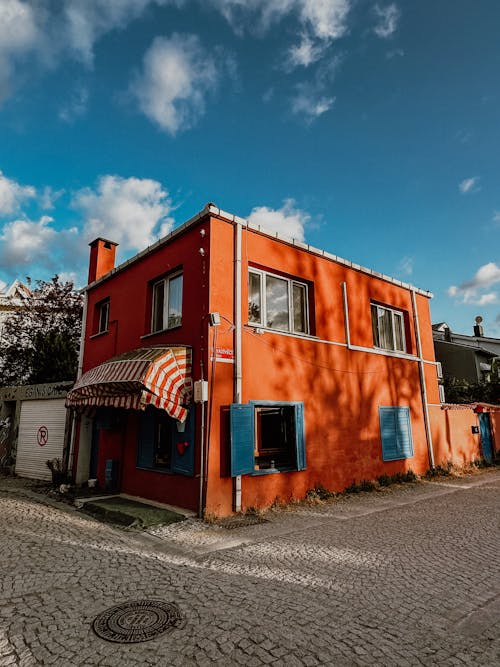 A red building with blue shutters on the side