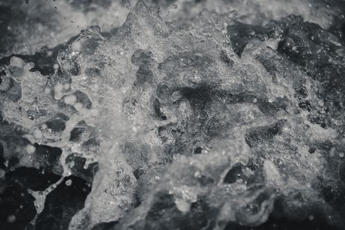 Free Dramatic black and white close-up of ocean water splashing with textured waves. Stock Photo