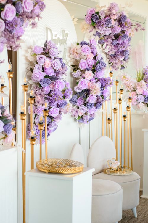 Free Lavish floral decor with purple hues and golden accents in a modern indoor setting. Stock Photo
