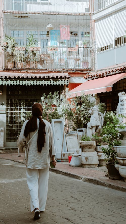 A woman walking down a street in a city