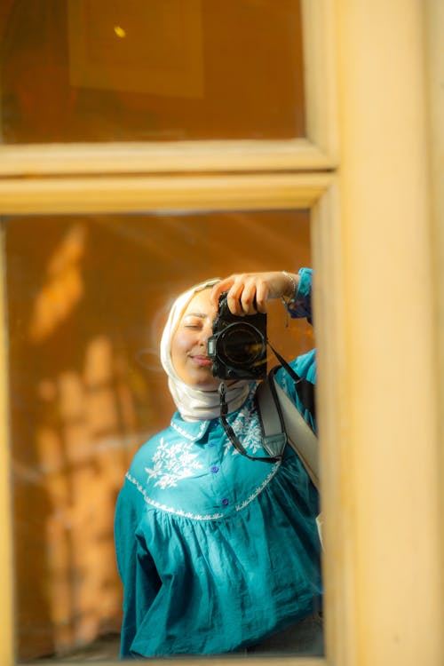 A woman taking a picture of herself in a mirror