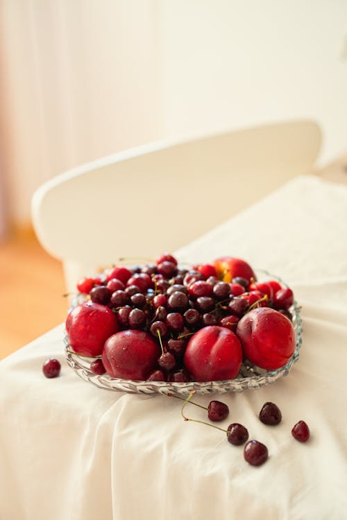 Free A bowl of cherries on a table Stock Photo