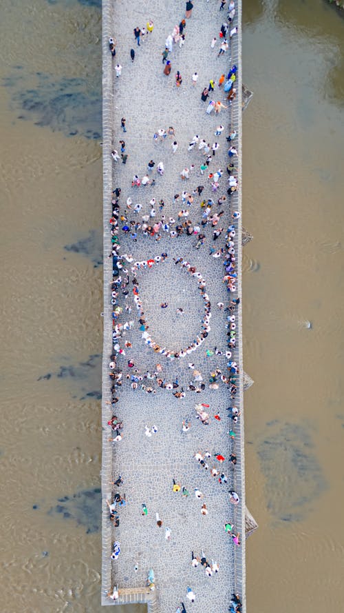 An aerial view of people standing on a bridge