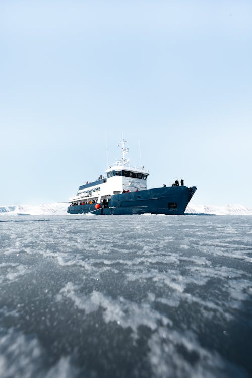 A boat is traveling through the ice