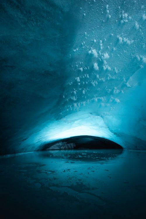 Free Explore a stunning ice cave with a captivating blue glow and serene icy landscape. Stock Photo