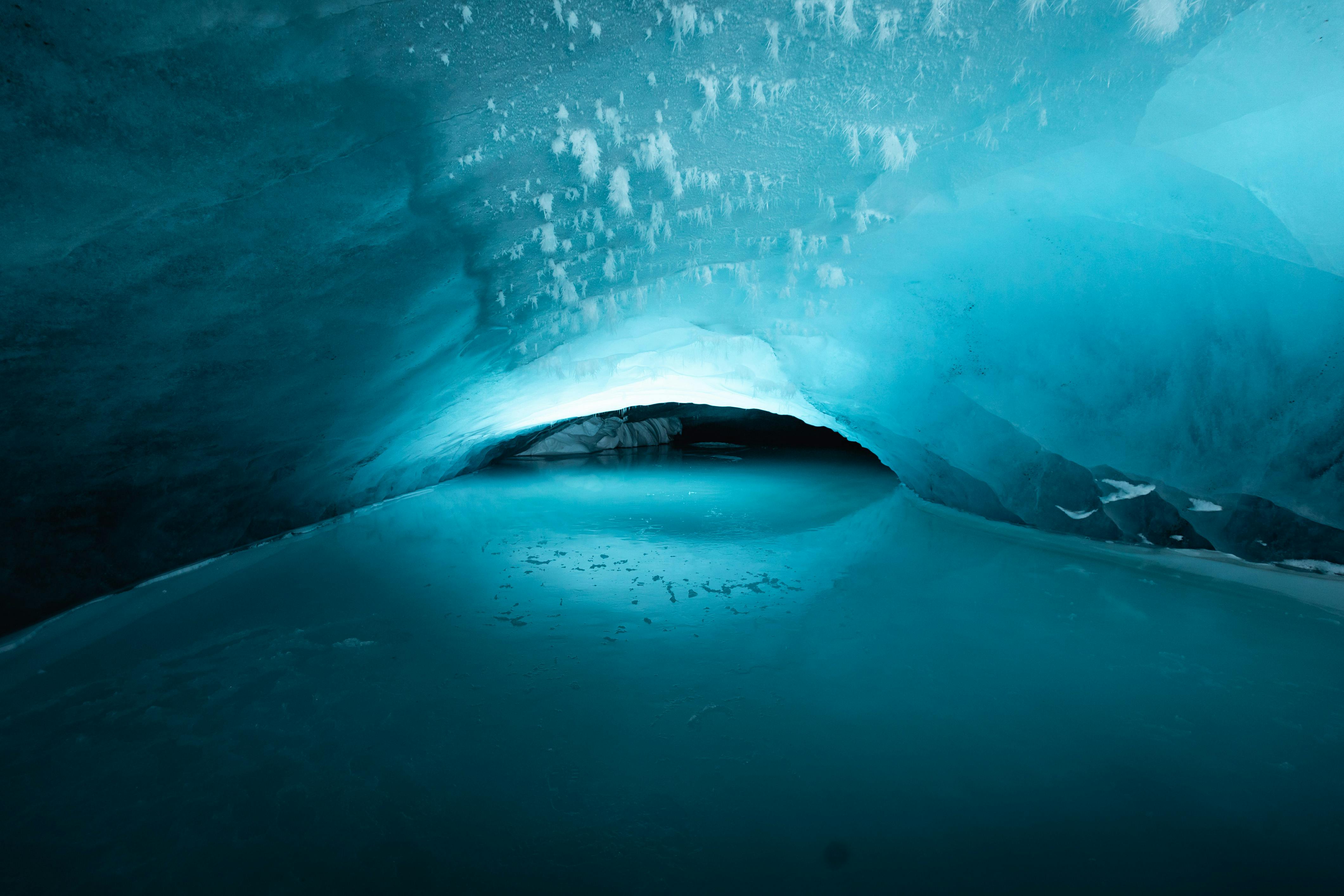 Explore the breathtaking blue ice cave with stunning icy formations in this arctic wonder.