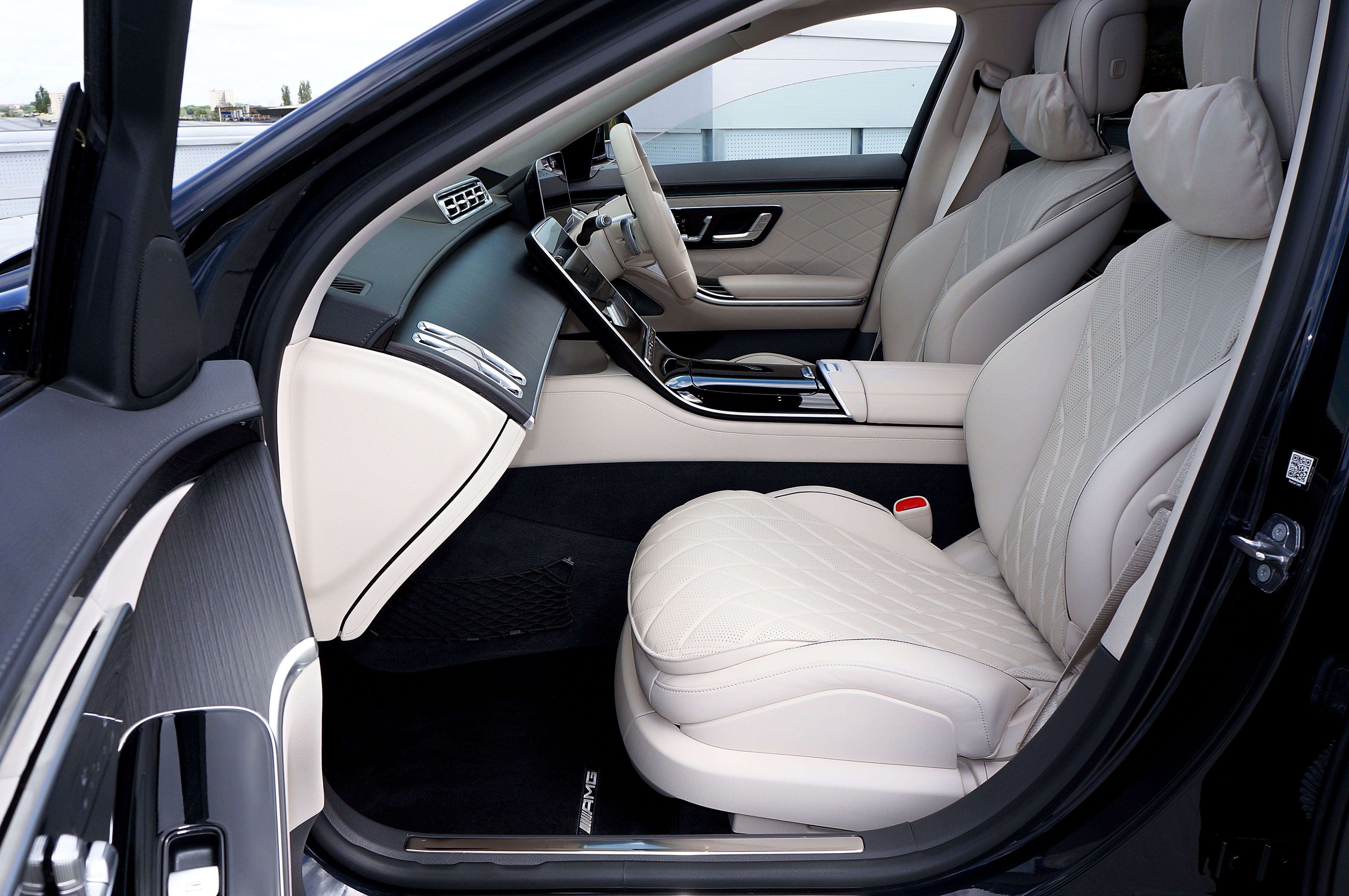 Modern luxury car interior with leather seats and a digital dashboard.