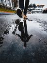 Reflection of a Person Wearing Orange Sneakers
