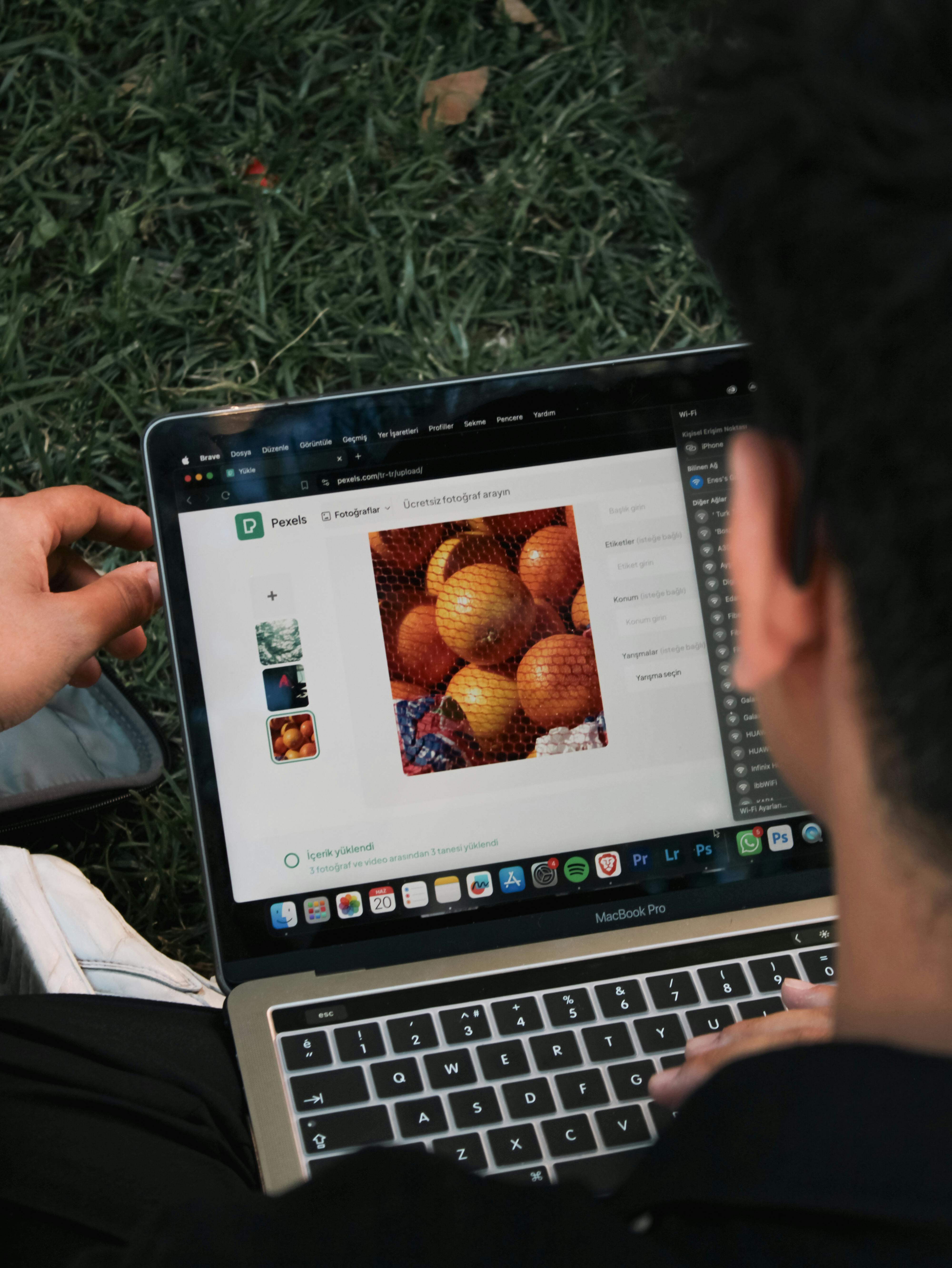 man sitting and watching picture of fruit