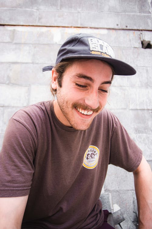 Man Smiling Wearing Black Fitted Cap