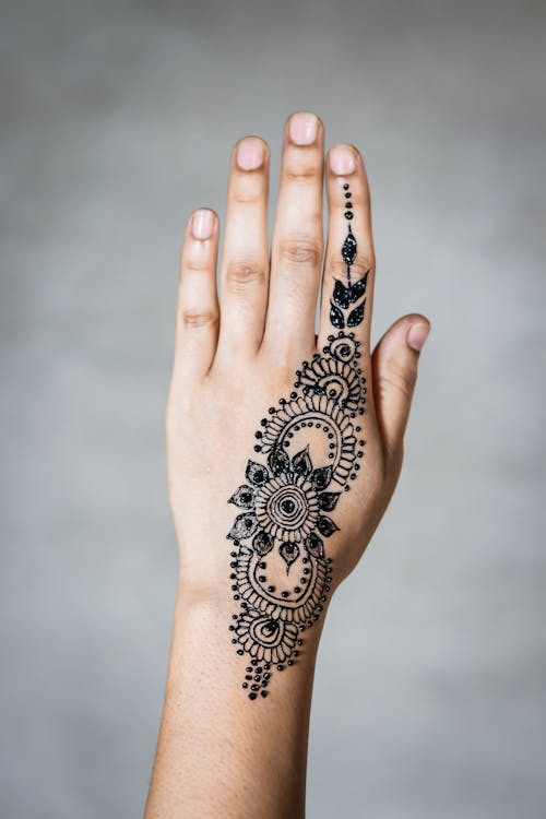 Person With Mandhi Tattoo On Hand