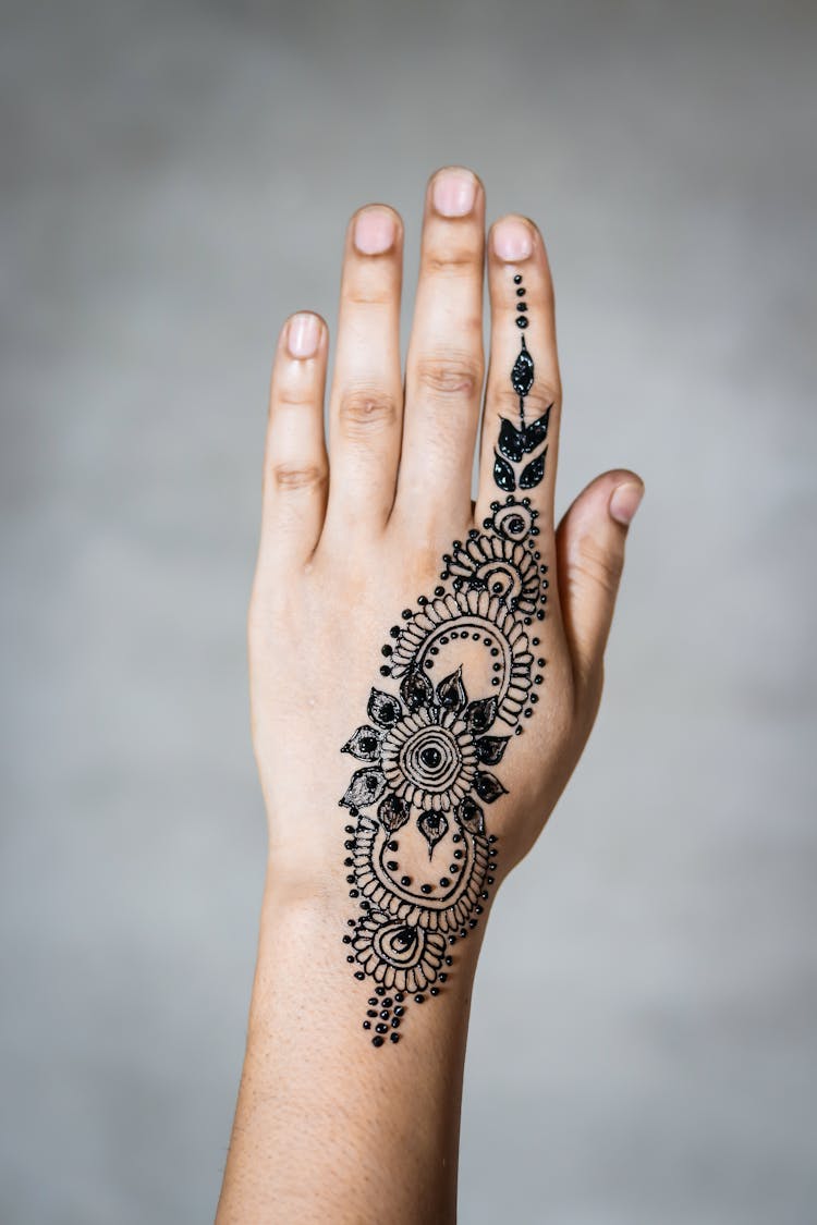 Person With Mandhi Tattoo On Hand