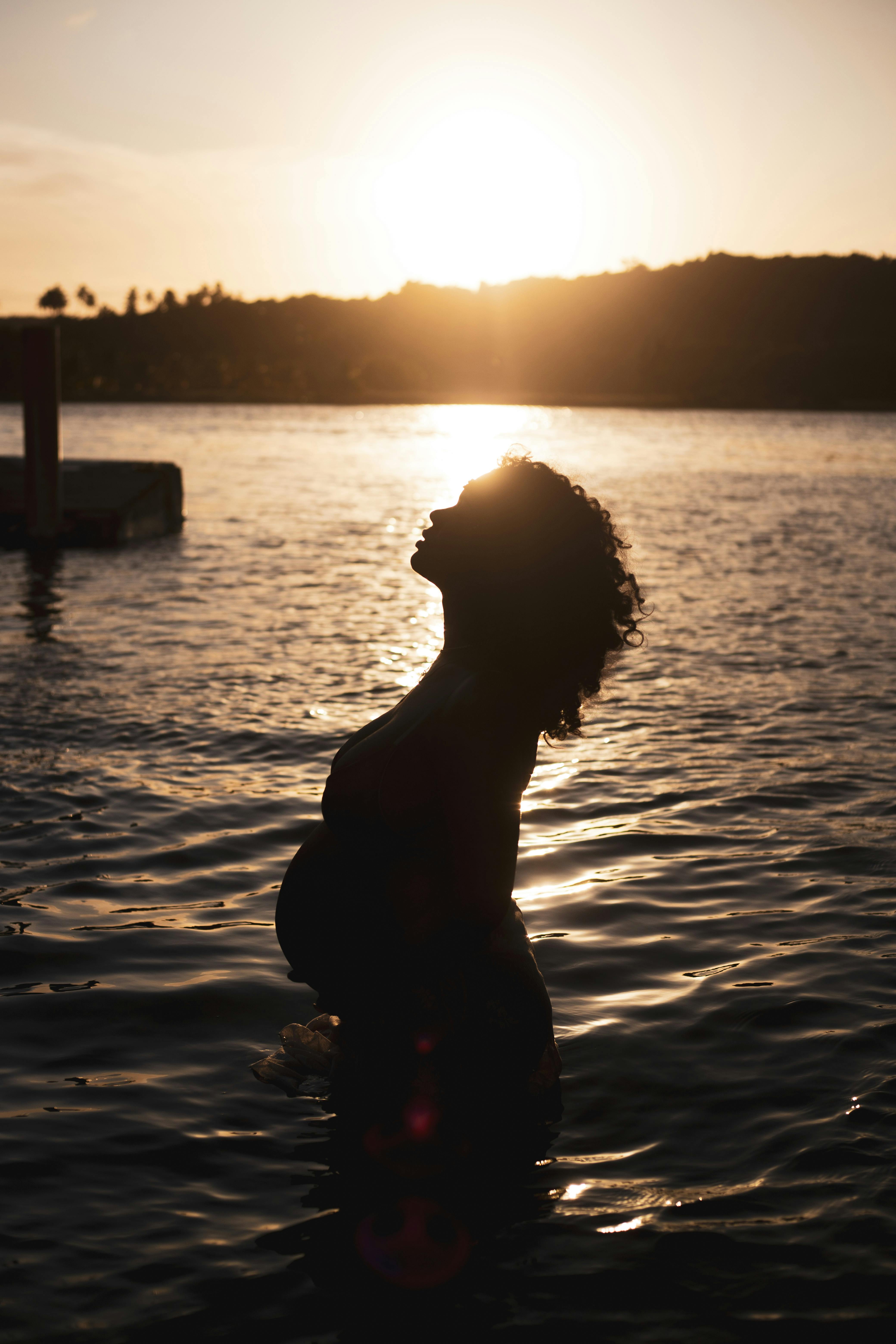 silhouette of pregnant woman in water