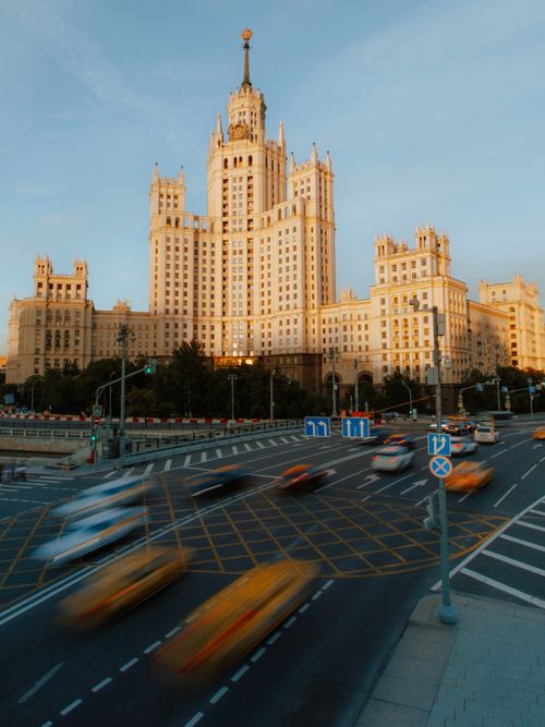 Free Dramatic view of a prominent Stalinist skyscraper in Moscow against a busy street. Stock Photo