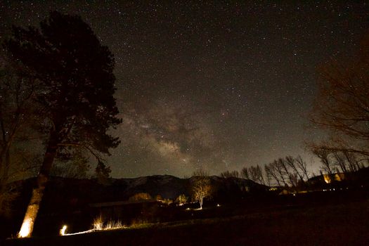 Breathtaking view of the Milky Way galaxy shining brightly over a serene, starry night landscape.