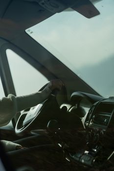 Interior view of a car from the driver's perspective, focusing on steering and dashboard.