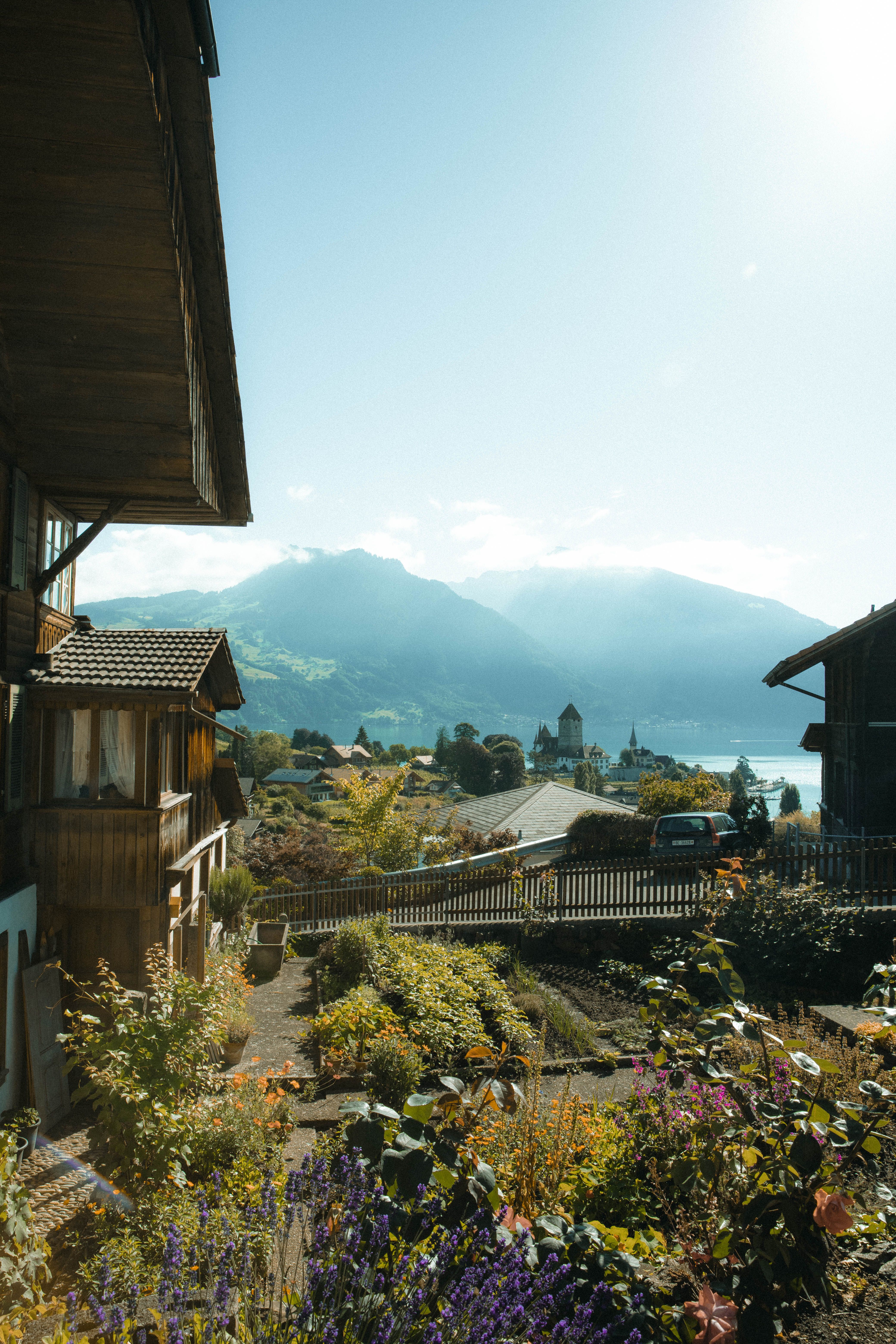 A house with flowers in front of it and mountains · Free Stock Photo