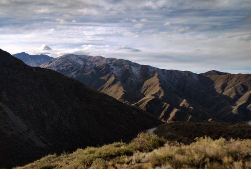 Free Captivating view of a mountainous landscape with dramatic shadows and a cloudy sky. Stock Photo